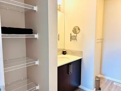 a bathroom with a sink and a mirror at Sunlit Haven in Calgary