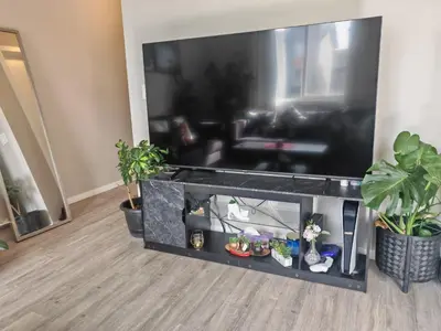 a living room with a large flat screen tv at Sunlit Haven in Calgary