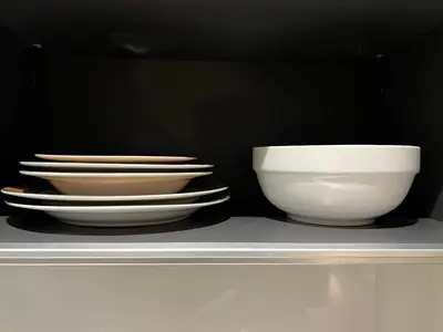 two white bowls and plates sitting on a shelf at Best location &comfortable room1B &1B Richmond center in Richmond