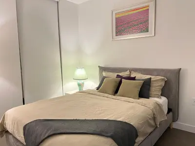 a bedroom with a large bed with a painting on the wall at Best location &comfortable room1B &1B Richmond center in Richmond