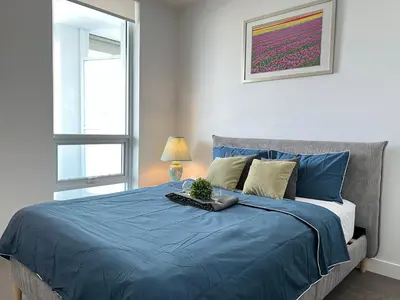 a bedroom with a blue bed with a plant on it at Best location &comfortable room1B &1B Richmond center in Richmond