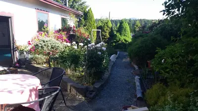 a garden with a table and some flowers at Timberlodge RV & Campground in Port Alberni