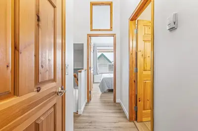 a hallway leading to a room with a door at Scenic 2BR Haven with MTN Views Near DT Banff in Canmore