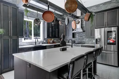 a kitchen with a large white island in a kitchen at Shawnigan Lake Retreat with Theatre in Shawnigan Lake