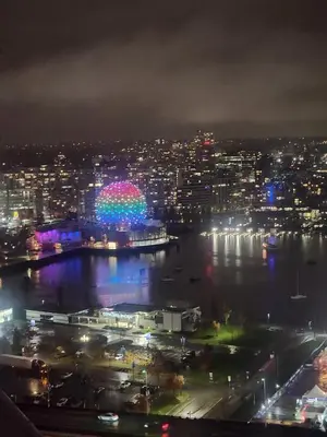 a view of a city at night with a river at Modern High-Rise 1 Bedroom Condo with water view near stadiums in Vancouver