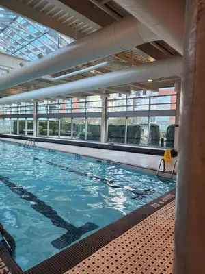 a large indoor swimming pool with blue water at Modern High-Rise 1 Bedroom Condo with water view near stadiums in Vancouver