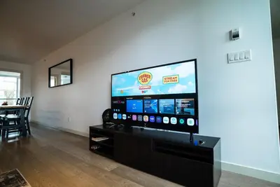 a living room with a large flat screen tv at #Modern & Cozy 2BR 2BA in the Heart of Chinatown in Vancouver