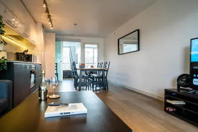 a living room and kitchen with a table and chairs at #Modern & Cozy 2BR 2BA in the Heart of Chinatown in Vancouver