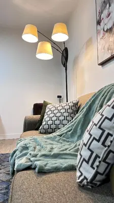 a living room with a couch with a blanket on it at Birdie on the Hill in Mission City