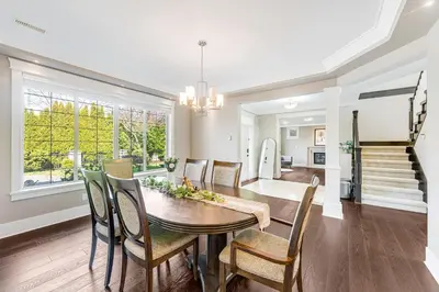 a dining room and living room with a table and chairs at Sunnymede Vacation Stay in Richmond