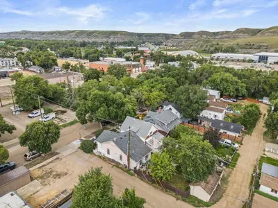 an aerial view of a town with houses at Downtown Den - Steps Away from Worlds Largest Dino in Drumheller