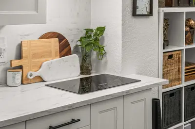 a kitchen counter with a sink and a vase on it at Downtown Den - Steps Away from Worlds Largest Dino in Drumheller