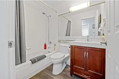 a bathroom with a toilet and a tub and a sink at Cozy 1 Bedroom Downtown Central in Vancouver
