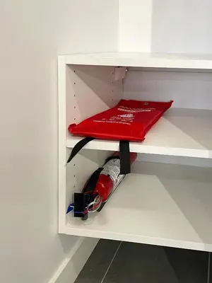 a white cabinet with a red object on a shelf at Condo Downtown Vancouver - Near Rogers Arena & BC Place w Parking in Vancouver