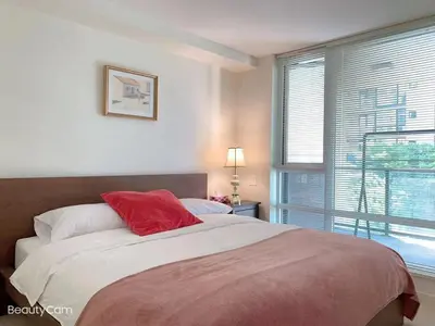 a bedroom with a large bed and a window at Cozy Perfect &elegant 2bed 1 bath in Richmond center in Richmond