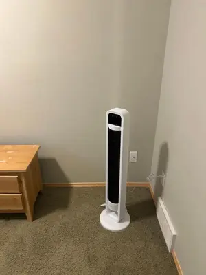 a black and white appliance in a corner of a room at Unique home services in Bélanger