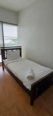 a large bed in a room with a large window at New Royal Inn in New Westminster