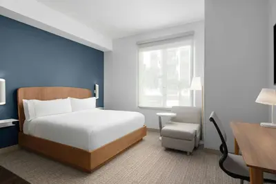 a bedroom with a bed and a desk and a chair at Element Calgary Downtown by Westin in Calgary