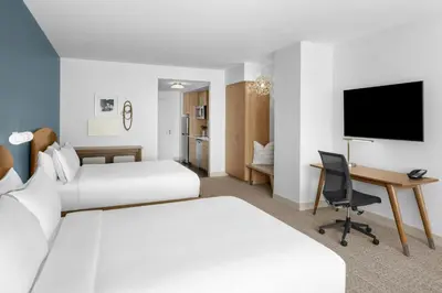 a hotel room with two beds and a desk at Element Calgary Downtown by Westin in Calgary