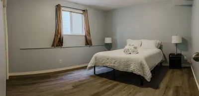 a bedroom with a bed with two stuffed animals on it at entire house THE BLUE DOOR with garage access in Grande Prairie