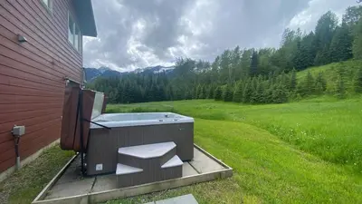 a hot tub sitting on the side of a house at Pet Friendly 3 Bdrm Home with Hot Tub by StayIn in Fernie