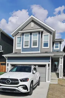 a white car parked in front of a house at Little Nest in Calgary