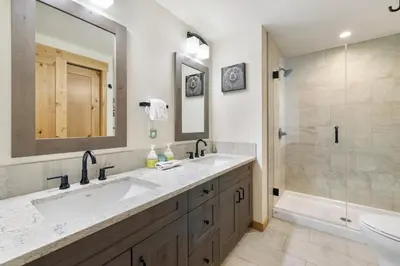 a bathroom with a sink and a shower and a tub at Spring Creek Corner Condo by Canadian Rockies Vacation Rentals in Canmore