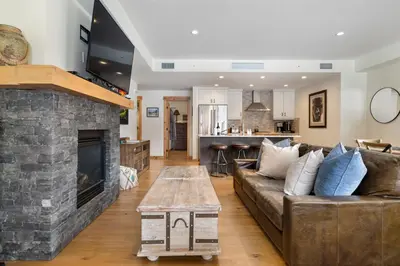 a living room with a couch and a fireplace at Spring Creek Corner Condo by Canadian Rockies Vacation Rentals in Canmore