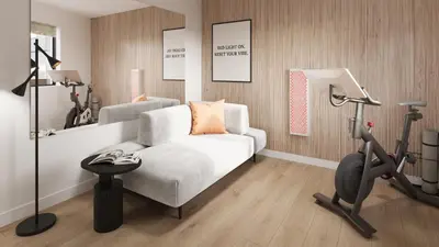 a living room with a white couch and a treadmill at The Como Hotel in Vancouver