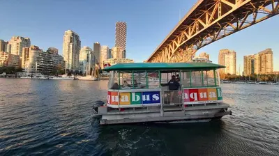 a boat in the water under a bridge at The Como Hotel in Vancouver