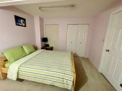 a bedroom with a large bed with green pillows at Imperial Ranchettes GuestSuite in Lone Butte