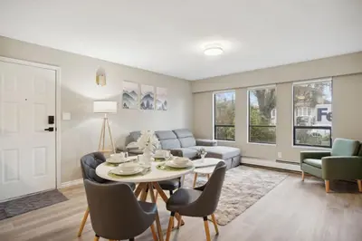 a living room with a table and a couch at 6 Bedroom Family Home with Indoor Arcade, BBQ, Huge Backyard & Pickleball in Vancouver