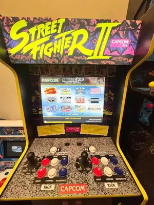 a street fighter ii arcade game in a store at 6 Bedroom Family Home with Indoor Arcade, BBQ, Huge Backyard & Pickleball in Vancouver