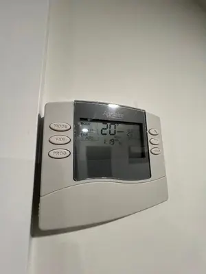 a close up of an electronic device on a wall at Comfy & Modern 2 Bedroom Guest Suite with King Bed in Edmonton