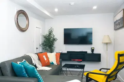 a living room with a couch and a tv at Comfy & Modern 2 Bedroom Guest Suite with King Bed in Edmonton