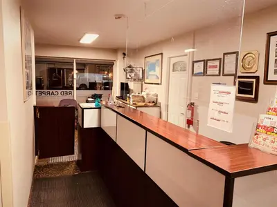a kitchen with a long counter in a room at Red Carpet Inn & Suites in Calgary