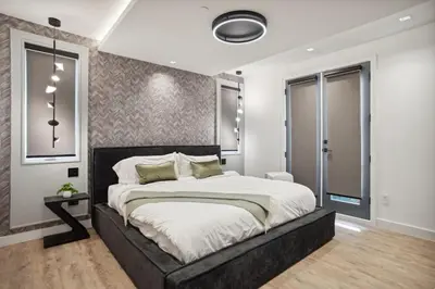 a bedroom with a large bed in a room at Luxury Downtown Vancouver Home Near Sunset Beach with Parking in Vancouver