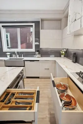 a large kitchen with white counters and a sink at Luxury Downtown Vancouver Home Near Sunset Beach with Parking in Vancouver