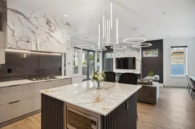 a kitchen with a island in the middle of a room at Luxury Downtown Vancouver Home Near Sunset Beach with Parking in Vancouver