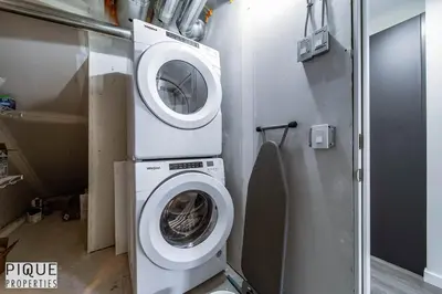 a washing machine in a room with a washer at NEW-The Suite Life-2BD-King Bed-WEM & YEG Airport in Edmonton