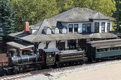 a model train in front of a house at NEW-The Suite Life-2BD-King Bed-WEM & YEG Airport in Edmonton