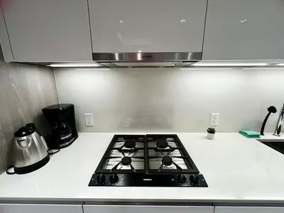 a kitchen with a stove top oven in a kitchen at Exquisite 1bed 1 bath locates in city center in Richmond
