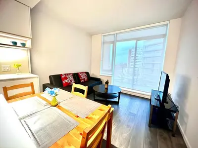 a living room with a table and a couch at Exquisite 1bed 1 bath locates in city center in Richmond