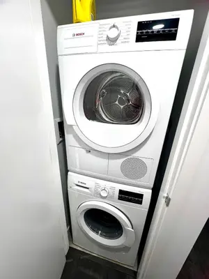 a washer and dryer sitting in a room at Exquisite 1bed 1 bath locates in city center in Richmond