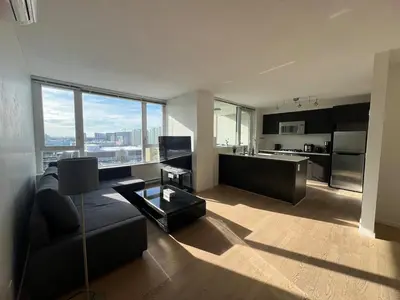 a living room with a couch and a kitchen at Elegant &comfortable room1B &1B apartment perfect location in Richmond