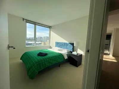 a bedroom with a green bed and a window at Elegant &comfortable room1B &1B apartment perfect location in Richmond