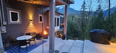 a patio with a table and chairs on a house at Casa del Rio - Peaceful River Guest Suite -Forests -Mountains -Hiking in Chilliwack