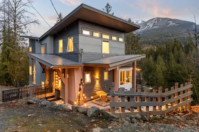 a house with a fence in front of it at Casa del Rio - Peaceful River Guest Suite -Forests -Mountains -Hiking in Chilliwack