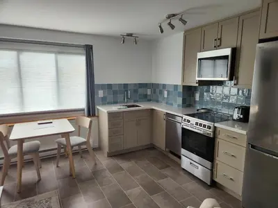 a kitchen with a table and a small table and chairs at D&G Suite Retreat in Sidney