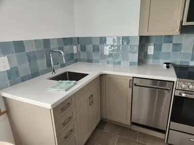 a kitchen with a sink and a stove at D&G Suite Retreat in Sidney